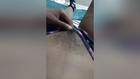 Ebony teen is touching her hairy body and getting a nice look