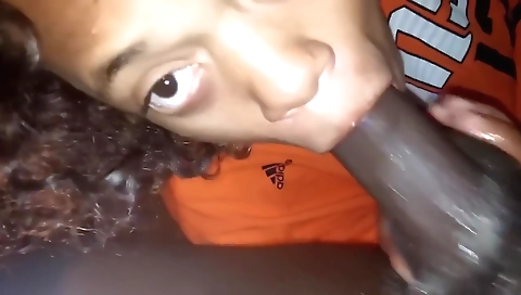 Ebony mature with a shaved pussy sucking on a big cock