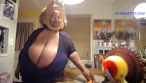 Busty ebony chick with a shaved pussy is giving a blowjob