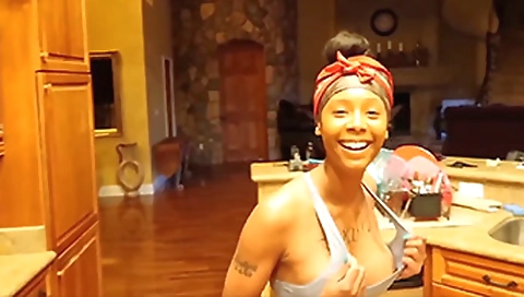 Sexy ebony brunette watching favorite video on the webcam