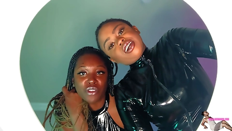 Busty ebony and latex girl in lingerie are showing off